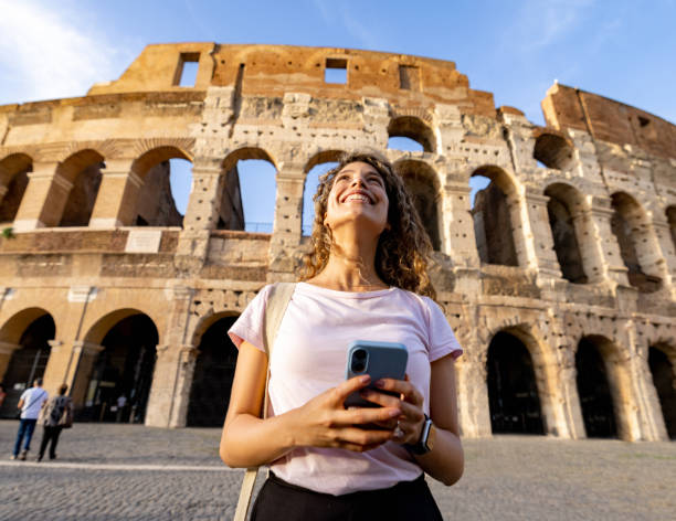 happy tourist in rome visiting the coliseum