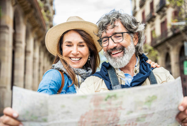 married couple of tourists sightseeing city street with map happy husband and wife enjoyi