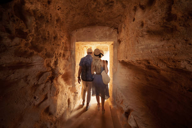 tourists walking in dark passage at archaeological site in greece