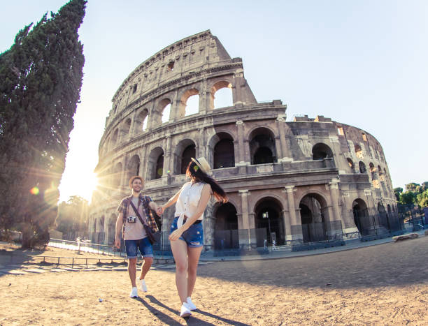 young happy couple of tourist walking holding hands at colosseum come with me rome italy